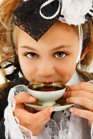 Beautiful Tween Girl in Cosplay Fashion Sipping Teaの写真素材