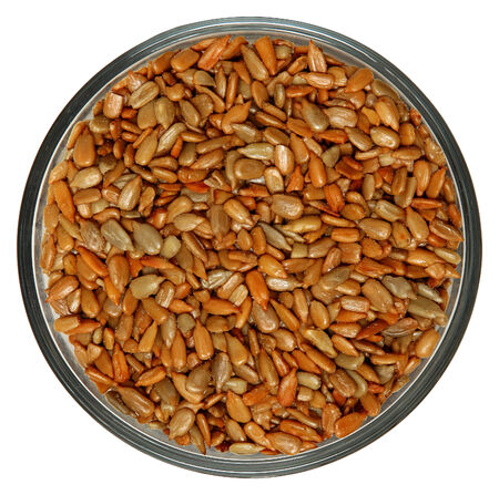 Roasted Salted Sunflower Seeds in Bowl High Angle View Over Whiteの写真素材