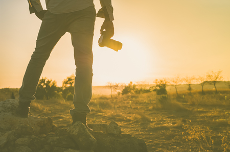 Black photographer taking pictures at sunset. Image with copy space.の写真素材