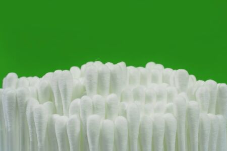 Cotton bud with green backgroundの写真素材