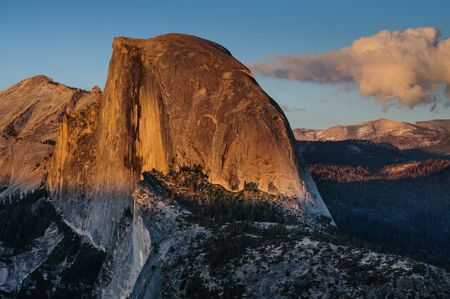 Setting sun illuminating the top of Half Dome, Yosemite National Park, USA.の写真素材