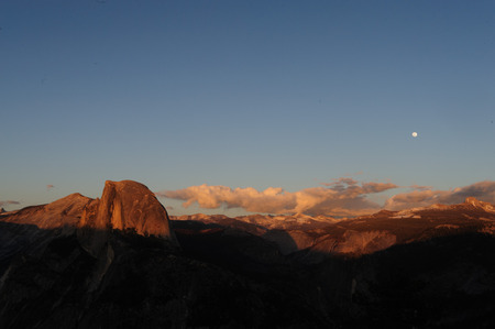 The setting sun illuminates Half dome, as seen from Glacier Point. Yosemite National Park, California, USA.の写真素材