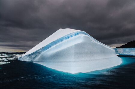 Iceberg floating off the Coast of Brown Bluff, on the tip of the Antarctic Peninsulaの写真素材