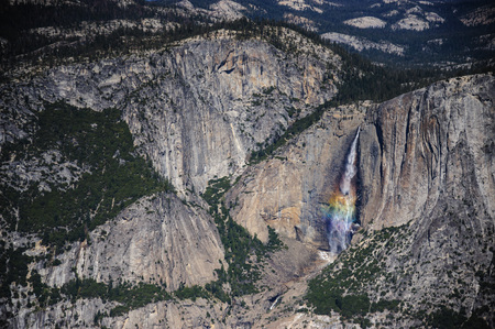 A Rainbow is cast by the Upper Yosemite Falls, as seen from Glacier Point.の写真素材