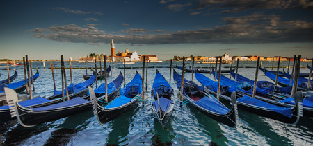 Gondolas in Venice, Italy, seen againts the backdrop of the Church of the San Giorgio Maggiore.の写真素材