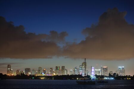 The skyline of Down Town Miami at Night, as seen from South Miami Beachの写真素材