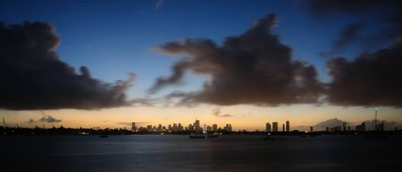 The skyline of Down Town Miami at Night, as seen from South Miami Beachの写真素材