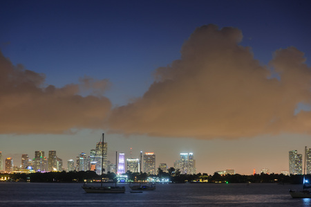 The skyline of Down Town Miami at Night, as seen from South Miami Beachの写真素材