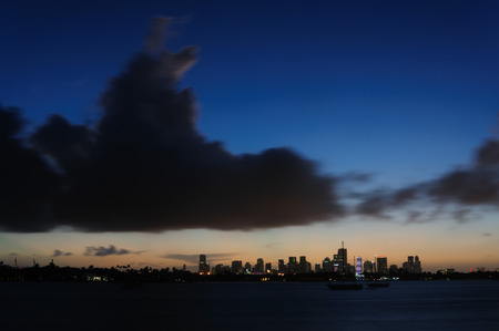 The skyline of Down Town Miami at Night, as seen from South Miami Beachの写真素材