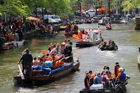 AMSTERDAM, NETHERLANDS - APRIL 30. Young People Celebrating Queensday in Amsterdam. Queensday is a popular annual festival celebrating the Queens Birthday.のeditorial素材