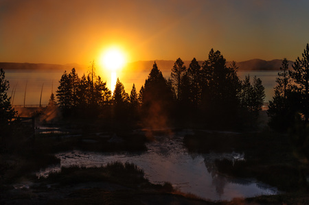A sunrise in the West Thumb Area in Yellowstone National Parkの写真素材