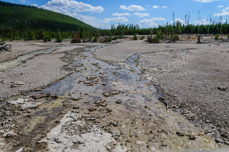 Flowing water across the mud planes in the Norris Geyser Basin in Yellowstone National Parkの写真素材