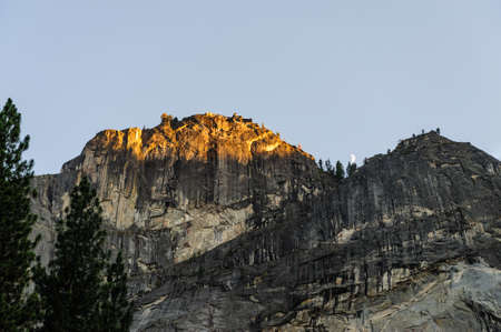 The setting sun illuminates parts of Half Dome with bright golden colors. This particular sunset was shot from the floor of Yosemite Valley, in Yosemite National Parkの写真素材