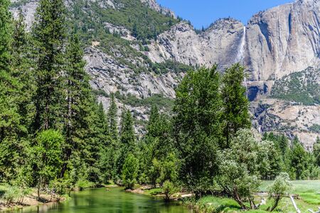 The Merced river on a late July afternoon, with the upper yosemite falls in the background. Yosemite National Park, California, USA.の写真素材