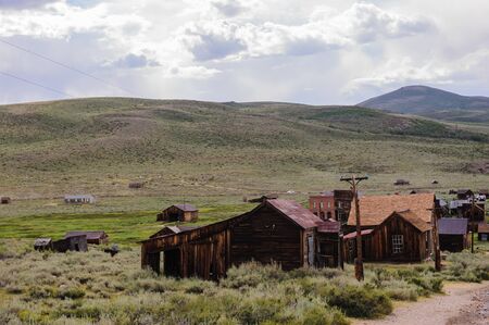 Ruined Buildings in the Californian Ghost Town of Bodie. Bodie is one of the best preserved Ghost Towns in America and was founded during the Californian Gold Rush. It was inhabited until the 1970s.の写真素材