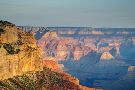Sunrise over the Grand Canyon, on an early August Morning. The rising sun is casting long dramatic shadows over the Red Rocks of the Canyon. Grand Canyon National Park, Arizona, USA.の写真素材