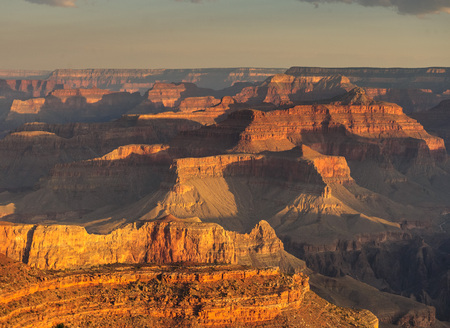 Sunrise over the Grand Canyon, on an early August Morning. The rising sun is casting long dramatic shadows over the Red Rocks of the Canyon. Grand Canyon National Park, Arizona, USA.の写真素材