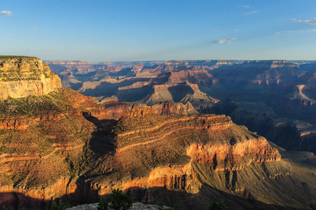 Sunrise over the Grand Canyon, on an early August Morning. The rising sun is casting long dramatic shadows over the Red Rocks of the Canyon. Grand Canyon National Park, Arizona, USA.の写真素材