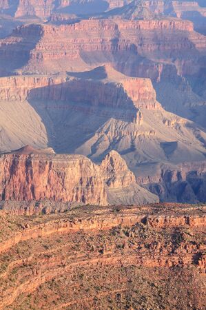 Sunrise over the Grand Canyon, on an early August Morning. The rising sun is casting long dramatic shadows over the Red Rocks of the Canyon. Grand Canyon National Park, Arizona, USA.の写真素材