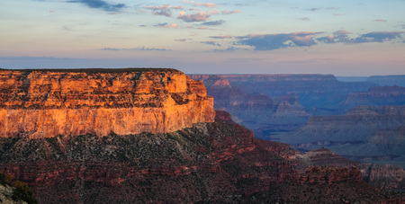 Sunrise over the Grand Canyon, on an early August Morning. The rising sun is casting long dramatic shadows over the Red Rocks of the Canyon. Grand Canyon National Park, Arizona, USA.の写真素材