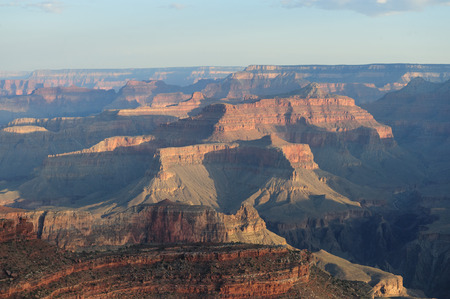 Sunrise over the Grand Canyon, on an early August Morning. The rising sun is casting long dramatic shadows over the Red Rocks of the Canyon. Grand Canyon National Park, Arizona, USA.の写真素材