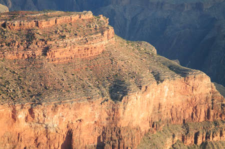 Sunrise over the Grand Canyon, on an early August Morning. The rising sun is casting long dramatic shadows over the Red Rocks of the Canyon. Grand Canyon National Park, Arizona, USA.の写真素材