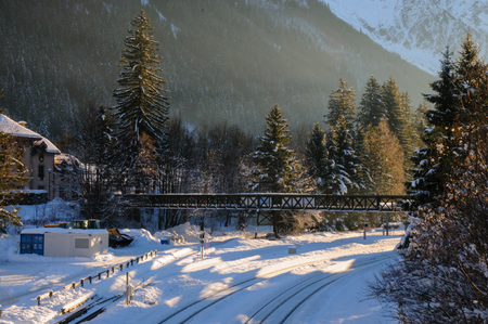 Low sun illuminatating a railroad track in the town of Chamonix-de-Mont Blanc on an early winters afternoonの写真素材