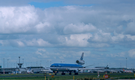 AMSTERDAM, NETHERLANDS, CIRCA SEPTEMBER 2001. An MD11 Passenger aircraft operated by KLM taking off from Schiphol airport . KLM was the last airline to operate an MD11 for passenger flights.のeditorial素材