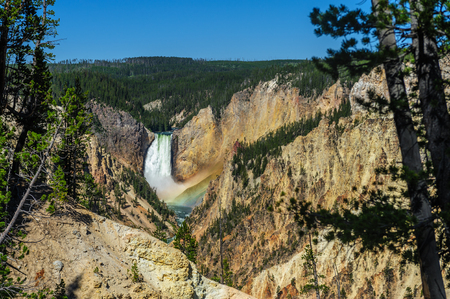 A rainbow in front of the Lower Falls of the Yellowstone river and canyonの写真素材
