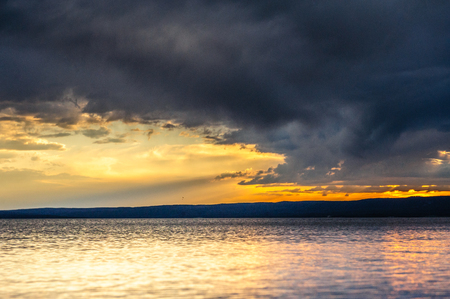 Illumination from the setting sun is reflected in the waves of Lake Yellowstone. Yellowstone National Park.の写真素材