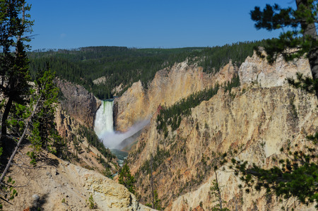 A rainbow in front of the Lower Falls of the Yellowstone river and canyonの写真素材