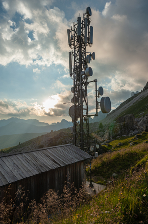 A radio mast at the Passo Gi Giao, in the italian Dolomites during sunset.の写真素材