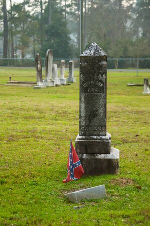Reevesville, SC. December 24, 2015. A confederate flag is posted near a gravestone at the Reevesville Cemetary..のeditorial素材