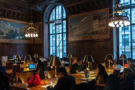 New York, USA, December 21, 2015. People being busy reading inside the famous New York Library.のeditorial素材