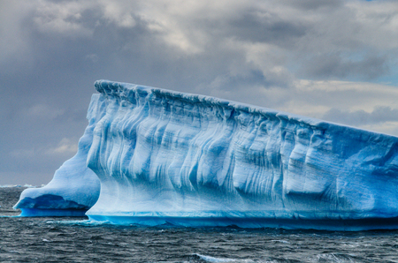 Giant icebergs floating off the Coast of Brown Bluff, the Northernmost tip of the Antarctic Peninsula. Storm Clouds are lining the Skies.の写真素材
