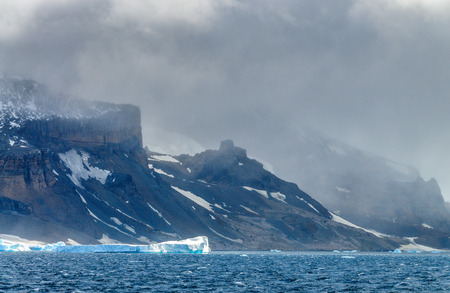 Giant icebergs floating off the Coast of Brown Bluff, the Northernmost tip of the Antarctic Peninsula. Storm Clouds are lining the Skies.の写真素材