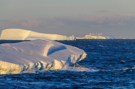 Antarctic Sunset: Floating Icebergs in the Weddell Sea, near the Antarctic Peninsula, as seen from an Antarctic Exploration Shipの写真素材