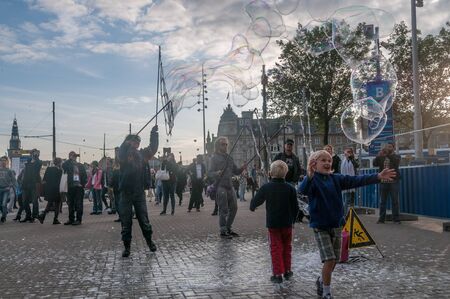 Amsterdam, Netherlands, September 28, 2015. Street artists throwing soap bubbles in Amsterdam, being...