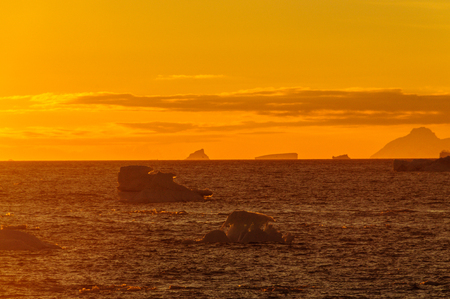 Antarctic Sunset: Floating Icebergs in the Weddell Sea, near the Antarctic Peninsula, as seen from an Antarctic Exploration Shipの写真素材