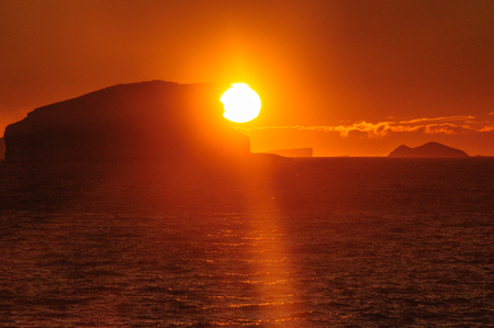 Antarctic Sunset: Floating Icebergs in the Weddell Sea, near the Antarctic Peninsula, as seen from an Antarctic Exploration Shipの写真素材