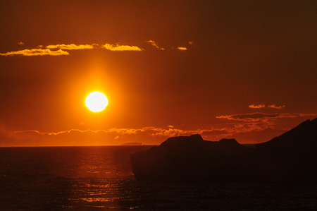 Antarctic Sunset: Floating Icebergs in the Weddell Sea, near the Antarctic Peninsula, as seen from an Antarctic Exploration Shipの写真素材