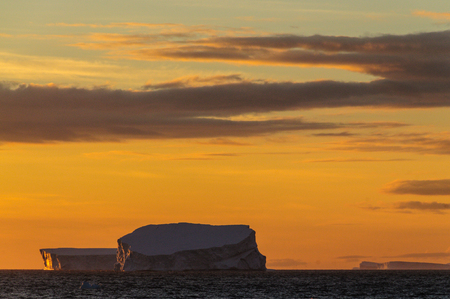 Antarctic Sunset: Floating Icebergs in the Weddell Sea, near the Antarctic Peninsula, as seen from an Antarctic Exploration Shipの写真素材
