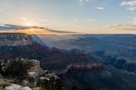 The setting sun sinking below the horizon of the Grand Canyon, near Yavapai point on the southern canyon rim.の写真素材