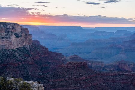The setting sun sinking below the horizon of the Grand Canyon, near Yavapai point on the southern canyon rim.の写真素材