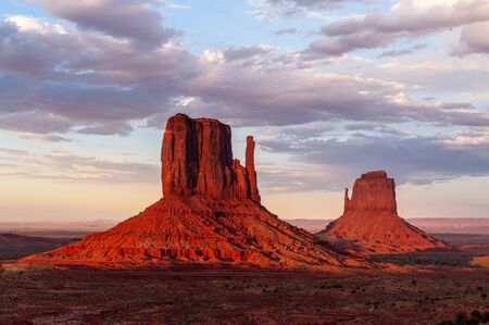 The famous Merrick and Mittens Buttes from monument valley basking in the Light of the setting sun.の写真素材