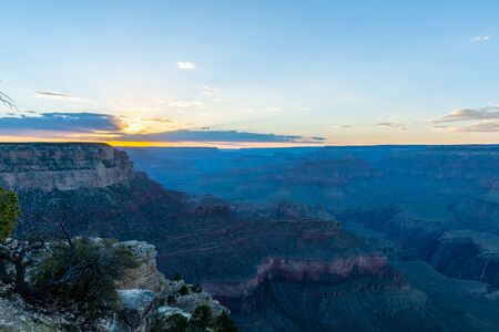 The setting sun sinking below the horizon of the Grand Canyon, near Yavapai point on the southern canyon rim.の写真素材