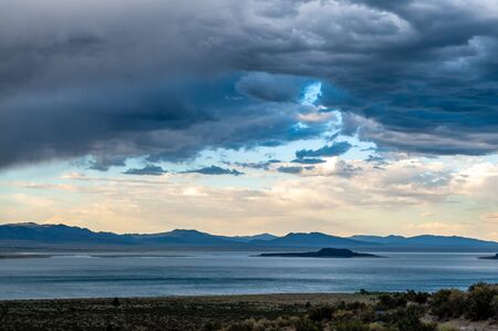 A dramatic sky higlighting the beauty of mono lake, California.の写真素材