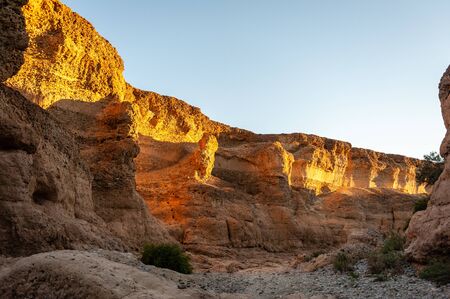 The walls of Sesriem canyon, Nambia, illuminated by the golden hour of the setting sun.の写真素材
