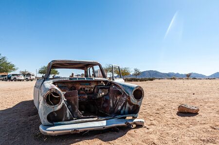 Wrecks of historic cars line the road in the town of Solitaire in the Khomas Region of Namibia.の写真素材