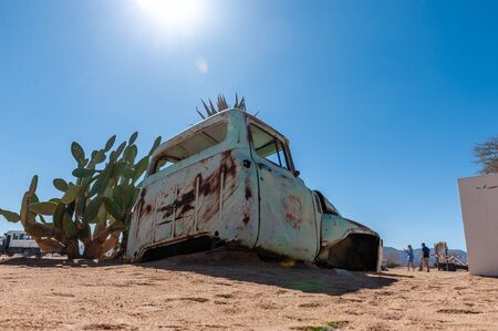 Wrecks of historic cars line the road in the town of Solitaire in the Khomas Region of Namibia.の写真素材